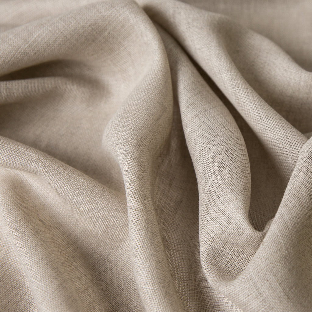 100 percent linen fabric macro with visible slubs indicating real breathable flax fibers